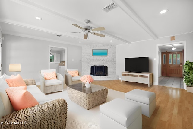 429 Linda Dr, Biloxi, MS 39531 - living room featuring ceiling fan, light wood-style flooring, beamed ceiling, a brick fireplace, and recessed lighting