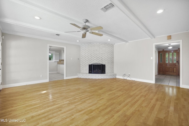 429 Linda Dr, Biloxi, MS 39531 - unfurnished living room with a ceiling fan, plenty of natural light, light wood-type flooring, a textured ceiling, and beamed ceiling