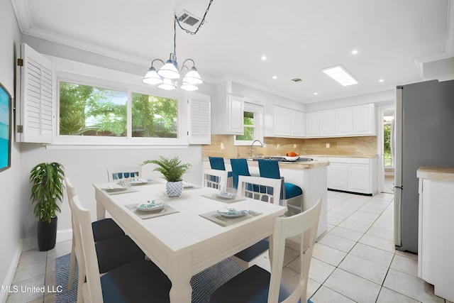 429 Linda Dr, Biloxi, MS 39531 - dining room with light tile patterned flooring, ornamental molding, a chandelier, and recessed lighting