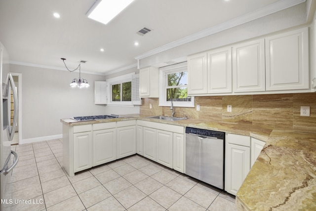 429 Linda Dr, Biloxi, MS 39531 - kitchen featuring stainless steel appliances, a peninsula, light countertops, decorative backsplash, and crown molding