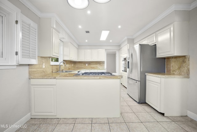 429 Linda Dr, Biloxi, MS 39531 - kitchen featuring appliances with stainless steel finishes, light countertops, a peninsula, tasteful backsplash, and recessed lighting