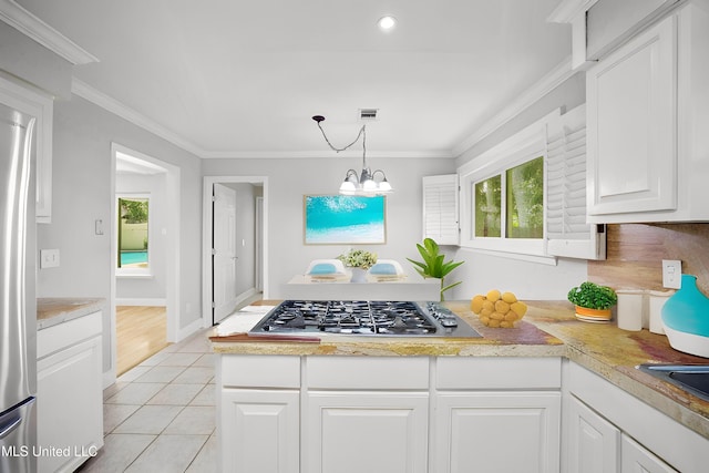 429 Linda Dr, Biloxi, MS 39531 - kitchen with stainless steel appliances, light countertops, ornamental molding, white cabinetry, and light tile patterned floors