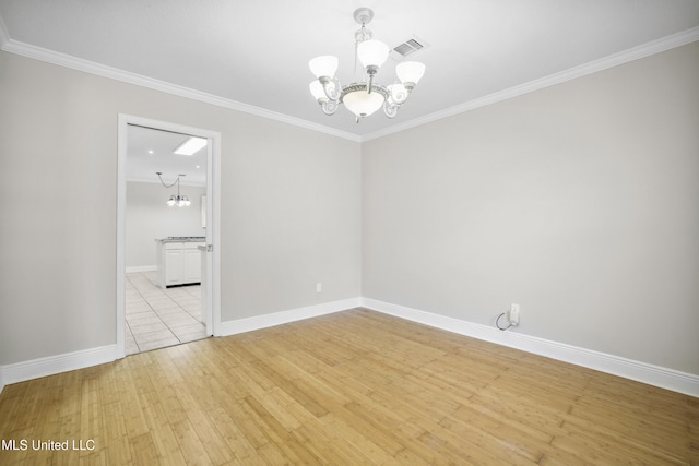 429 Linda Dr, Biloxi, MS 39531 - empty room with a chandelier, light wood-style floors, and crown molding