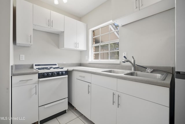 429 Linda Dr, Biloxi, MS 39531 - kitchen featuring white range with gas cooktop, white cabinetry, light tile patterned floors, and light countertops