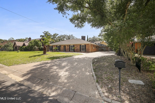 429 Linda Dr, Biloxi, MS 39531 - ranch-style house featuring a front yard, a chimney, concrete driveway, and brick siding