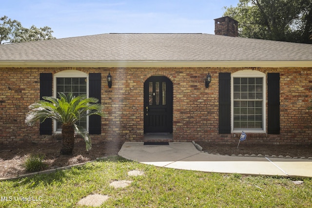 429 Linda Dr, Biloxi, MS 39531 - entrance to property with a shingled roof, a chimney, and brick siding