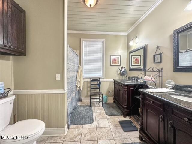 bathroom with toilet, ornamental molding, vanity, and tile patterned flooring