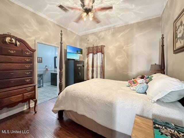 bedroom with connected bathroom, ornamental molding, wood-type flooring, and ceiling fan