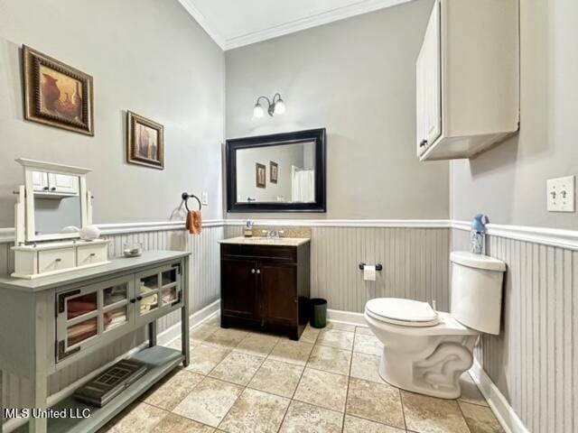 bathroom with vanity, toilet, and crown molding