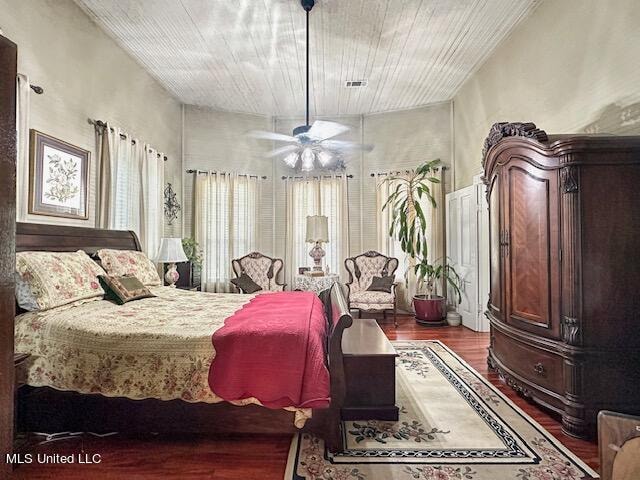 bedroom featuring ceiling fan, hardwood / wood-style flooring, and wooden ceiling