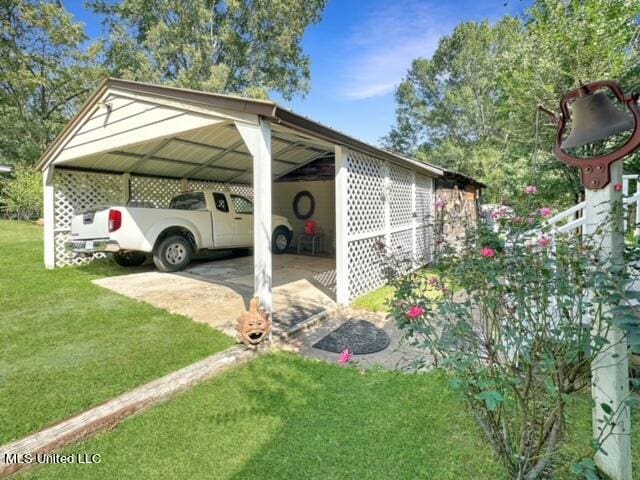 view of vehicle parking with a carport and a lawn