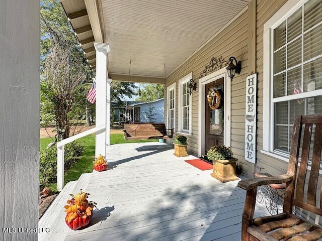 wooden terrace featuring covered porch