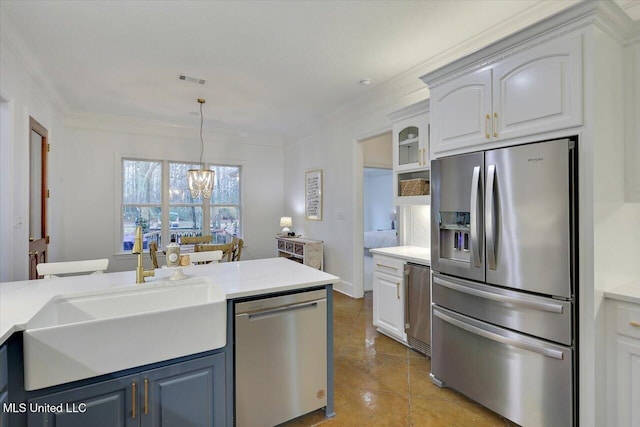 kitchen featuring sink, hanging light fixtures, stainless steel appliances, white cabinets, and light tile patterned flooring