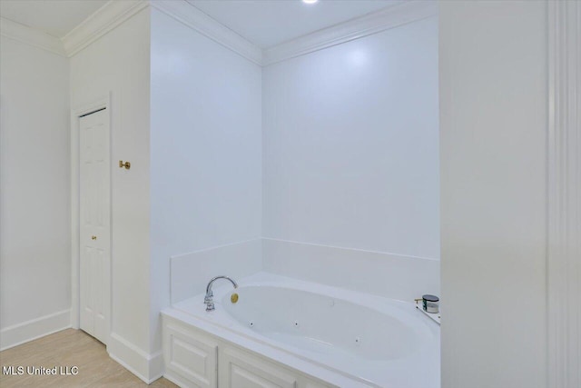 bathroom featuring ornamental molding and a bathing tub