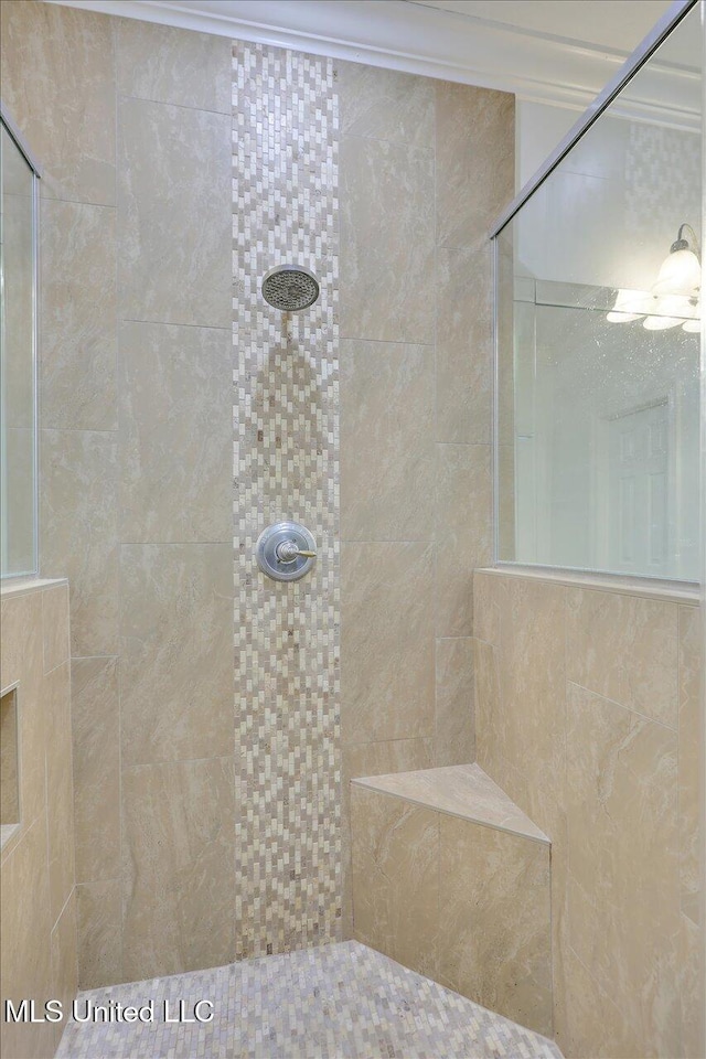 bathroom with a tile shower