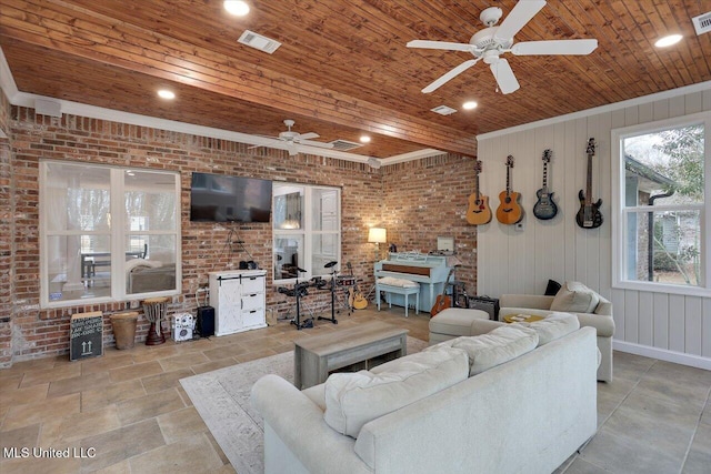 living room featuring wood ceiling, ceiling fan, brick wall, and wood walls