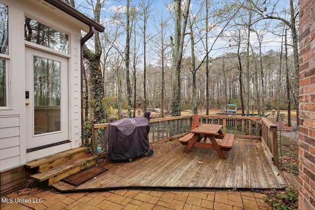 wooden deck with a grill