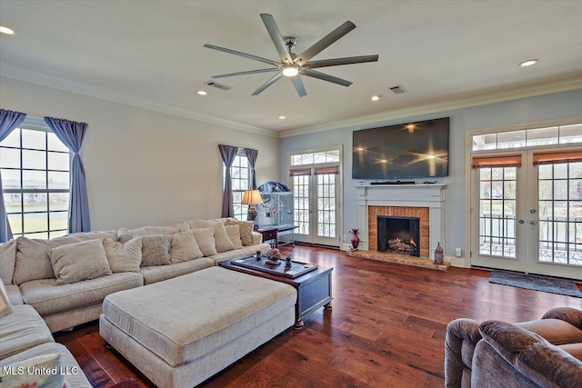 living room with french doors, visible vents, dark wood finished floors, and crown molding