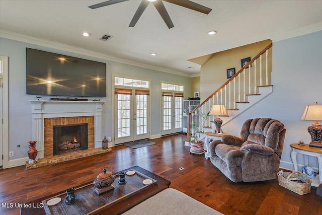 living area featuring visible vents, wood-type flooring, crown molding, and french doors