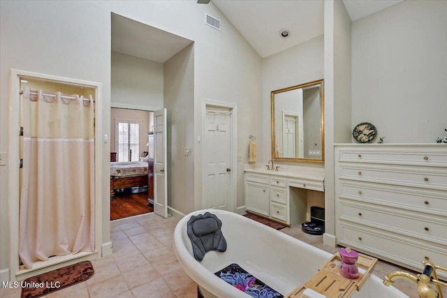 bathroom featuring vanity, visible vents, a soaking tub, tile patterned floors, and connected bathroom