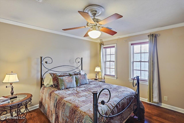 bedroom featuring crown molding, wood finished floors, baseboards, and visible vents