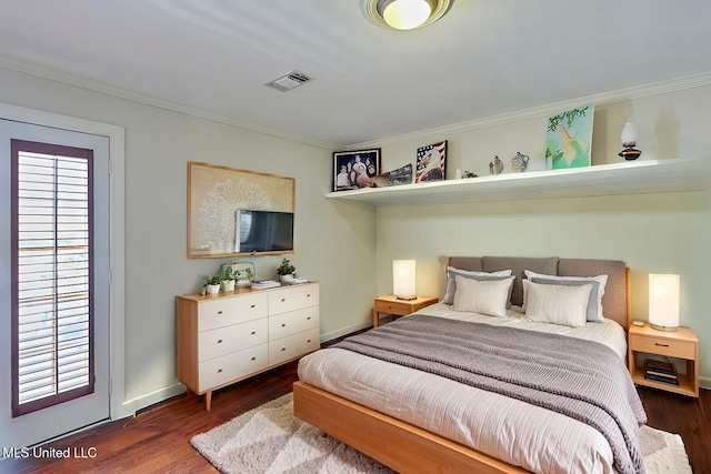 bedroom with visible vents, ornamental molding, baseboards, and wood finished floors