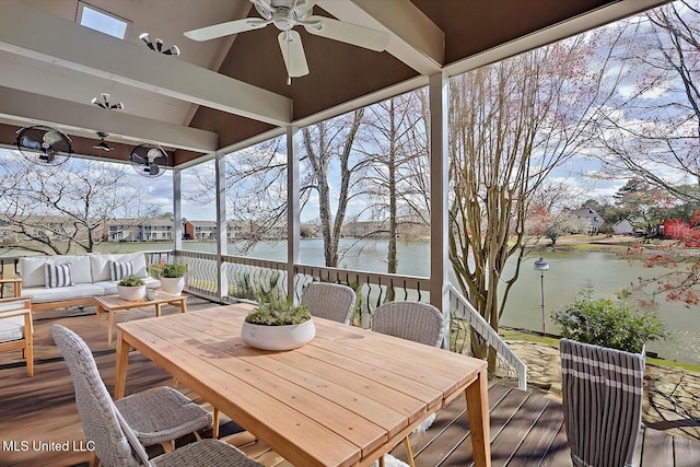 exterior space with an outdoor living space, outdoor dining area, a ceiling fan, and a water view