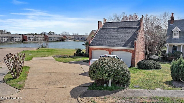 view of property exterior with a water view, a lawn, driveway, a shingled roof, and brick siding