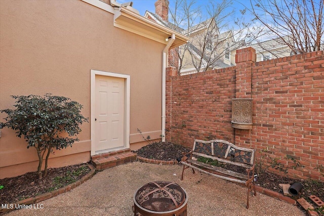 entrance to property featuring a patio and stucco siding