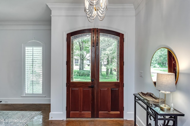 1025 Monet Cv, Brandon, MS 39047 - foyer entrance with a chandelier, crown molding, baseboards, and arched walkways