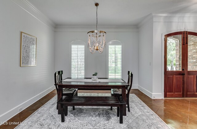 1025 Monet Cv, Brandon, MS 39047 - tiled dining room with a chandelier, ornamental molding, and baseboards