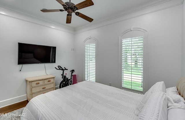 1025 Monet Cv, Brandon, MS 39047 - bedroom featuring dark wood-style flooring, baseboards, ornamental molding, multiple windows, and a ceiling fan