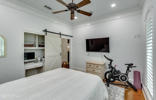1025 Monet Cv, Brandon, MS 39047 - bedroom featuring a barn door, crown molding, wood finished floors, baseboards, and a ceiling fan