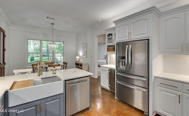 1025 Monet Cv, Brandon, MS 39047 - kitchen featuring appliances with stainless steel finishes, backsplash, a sink, light countertops, and crown molding