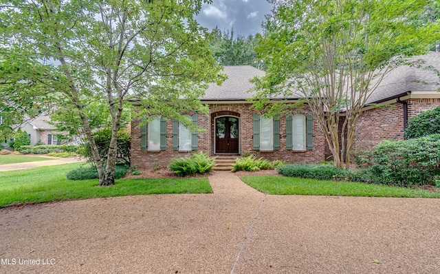 1025 Monet Cv, Brandon, MS 39047 - view of front of house with brick siding, roof with shingles, and a front lawn