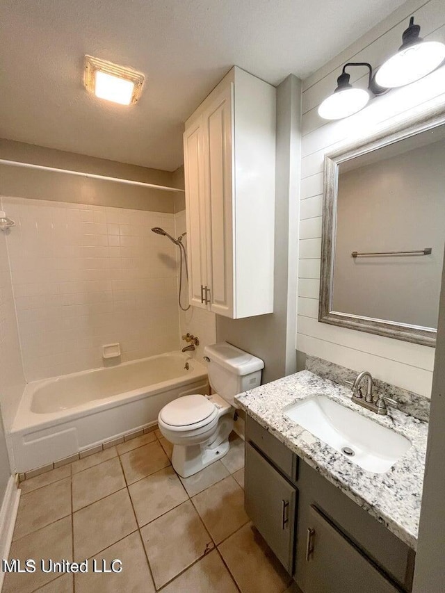 bathroom with toilet, tile patterned flooring, shower / bath combination, and vanity