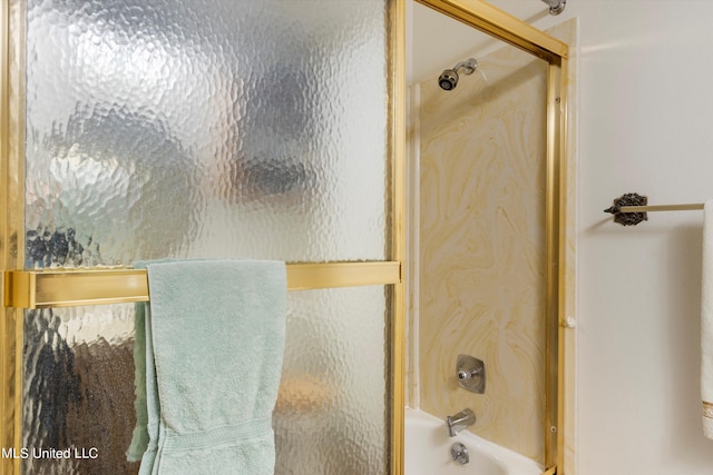 bathroom featuring bath / shower combo with glass door