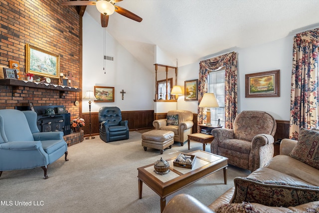 living room featuring ceiling fan, high vaulted ceiling, carpet floors, a wood stove, and wooden walls