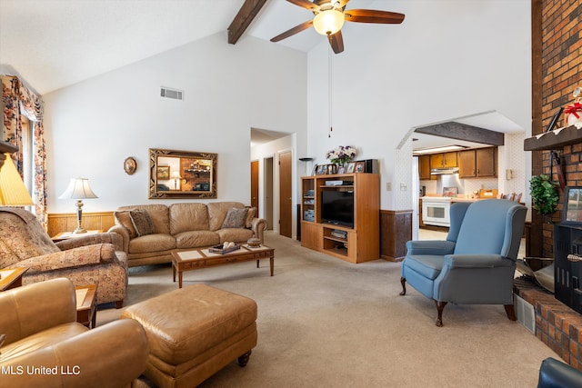 living room featuring light carpet, high vaulted ceiling, beam ceiling, and ceiling fan