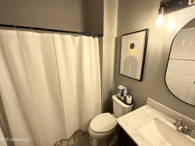 full bathroom with toilet, vanity, and a shower with shower curtain