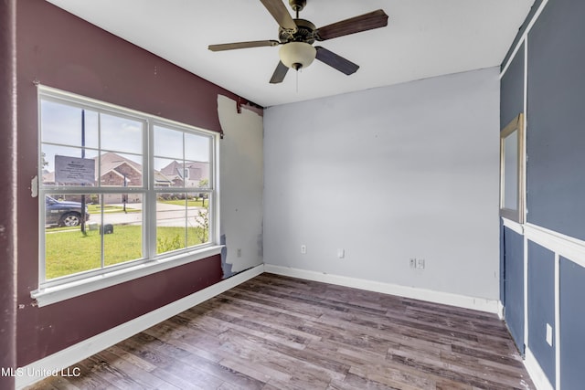 709 Champagne Dr, Biloxi, MS 39532 - unfurnished room featuring plenty of natural light, wood finished floors, and a ceiling fan