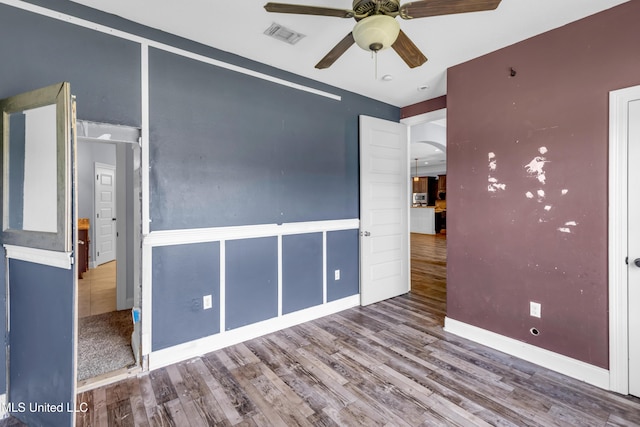 709 Champagne Dr, Biloxi, MS 39532 - unfurnished bedroom with wood finished floors and ceiling fan