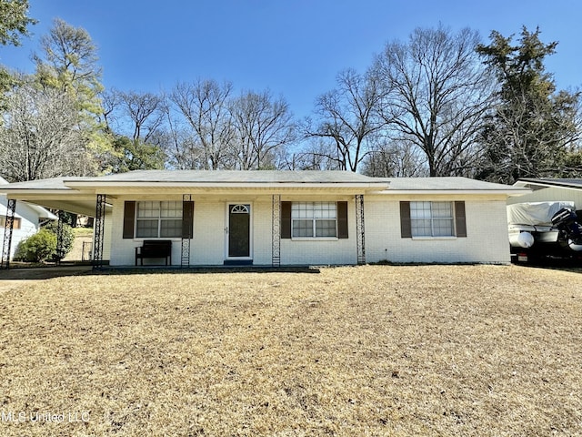 single story home featuring covered porch and brick siding