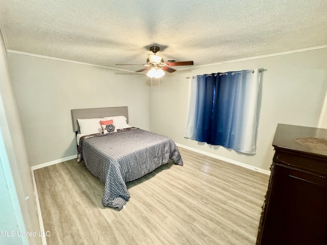 bedroom with a textured ceiling, light wood finished floors, a ceiling fan, and baseboards