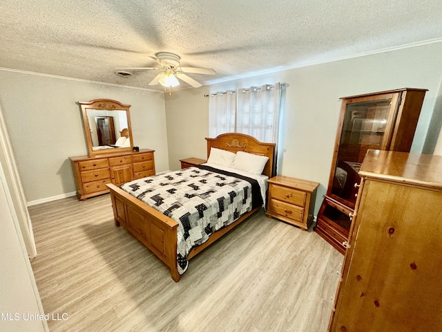 bedroom featuring visible vents, a ceiling fan, a textured ceiling, crown molding, and light wood-style floors