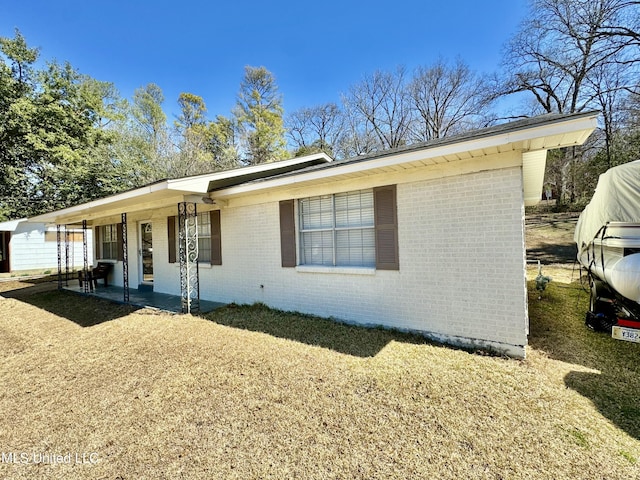 single story home featuring brick siding