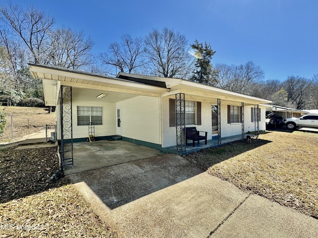 ranch-style house with driveway and brick siding