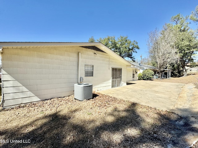 rear view of house featuring a patio area and cooling unit