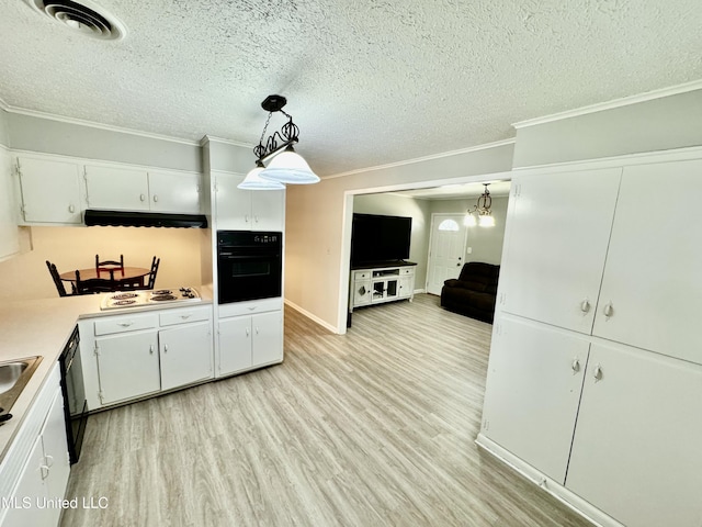 kitchen with white cabinets, ornamental molding, a textured ceiling, light wood-type flooring, and black appliances