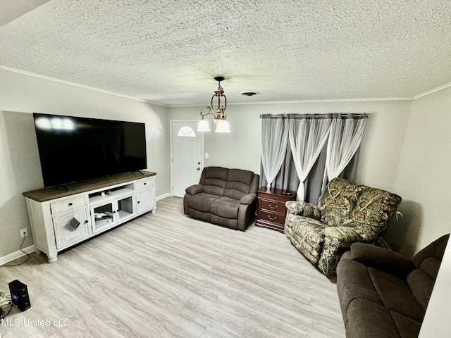 living area with a notable chandelier, visible vents, a textured ceiling, light wood-type flooring, and baseboards